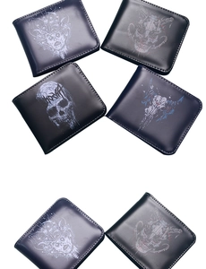 Detailed view of four men's skull print bifold wallets in black and navy leather finish