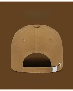 Detail of adjustable silver metal buckle on the back of a khaki distressed baseball cap