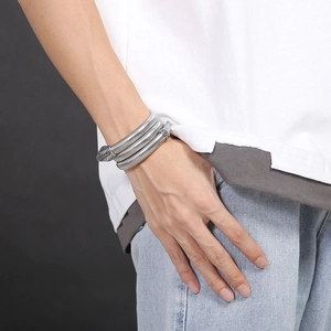 Detailed side view of silver snake-shaped multi-layer coiled bracelet on wrist