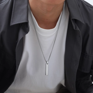 Silver geometric bar pendant necklace in stainless steel with box chain on a model