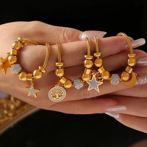 Elegant 18K gold-plated snake chain bracelet featuring tree of life and star pendants