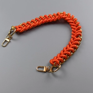 Detail of orange woven nylon and gold metal chain strap with spring hooks
