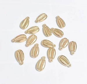 Macro view of gold-plated shell-shaped CCB pendants for DIY jewelry making