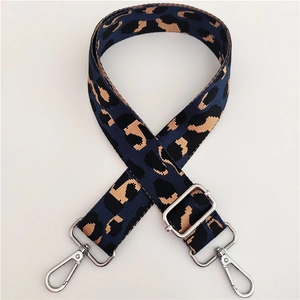 Detail of adjustable leopard print bag strap with silver metal swivel hooks and buckles
