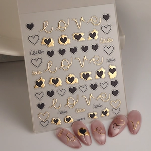 Detail of 5D heart embossed nail stickers with gold foil love script and chic cat-eye effect