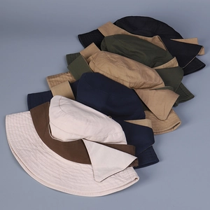 Close-up of assorted color washed cotton bucket hats showing reinforced brim stitching