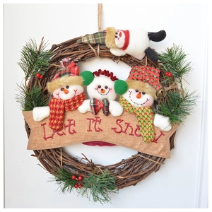 Detail of Let It Snow banner on rustic Christmas wreath with plush snowmen and pine needles