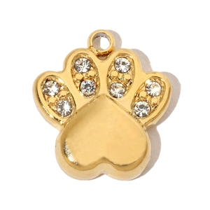 Macro detail of a golden paw pendant featuring zircon heart center and sparkling stones