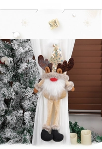 Detail of Christmas gnome reindeer curtain tieback on white sheer curtain