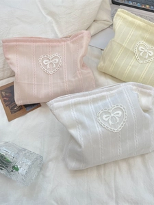 Pastel bow cosmetic bag with vertical lace texture and heart lace trim for travel storage