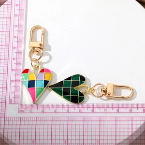 Checkered heart keychain in gold alloy featuring mosaic and green grid patterns