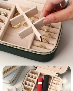 Detail of portable green velvet jewelry box showing flexible dividers and ring slots