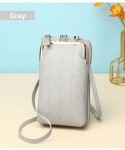 Close-up of gray quilted leather phone bag with vintage gold clasp and side zipper detail