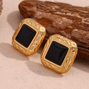 Detail of 18K gold-plated square studs with hammered texture and black acrylic inlay