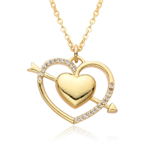 Macro shot of 18k gold heart pendant featuring sparkling zircons and a mirror reflection