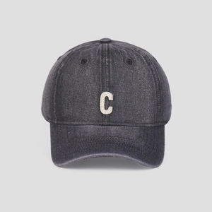 Detailed front view of washed denim baseball cap featuring white C patch embroidery