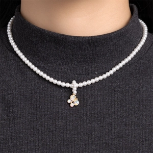 Elegant pearl necklace with gold butterfly pendant featuring crystals for women