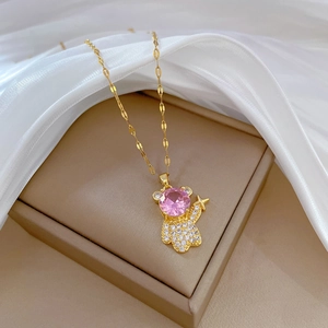 Luxurious gold bear pendant necklace with pink crystal and star details in jewelry box