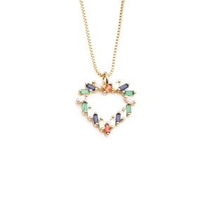 Exaggerated gold plated heart necklace with colorful baguette-cut stones on white background