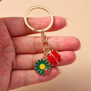 Pastel enamel ladybug and flower keychain accessory with gold-tone finish for bags