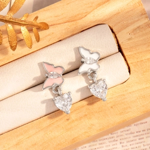 Pink and white butterfly earrings with heart zircon pendants in a jewelry box