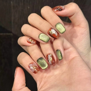 Retro handmade press-on nails with amber gradient, olive green cat-eye, and gold foil