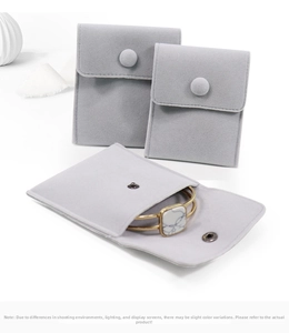 Detail of grey velvet jewelry pouches in multiple sizes with a snap button closure