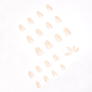 Floral press-on nails with white daisy patterns on a translucent pink coffin nail set
