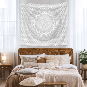 Detail of bohemian mandala tapestry featuring grey geometric patterns on a white cloth base