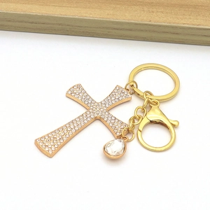Golden cross keychain with sparkling rhinestones and a large crystal teardrop charm