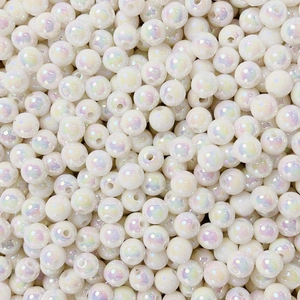 Macro shot of 8-12mm luminous cream round beads with iridescent pearl finish for DIY jewelry