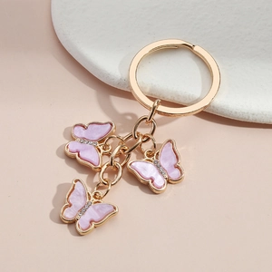 Pink pearl butterfly keychain with gold ring and crystals for bags and luggage