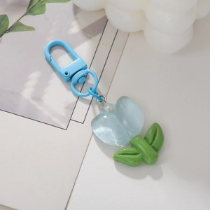 Handmade light blue tulip flower keychain with green leaves and blue metal spring hook