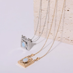 Detail of vintage starburst pendant necklaces with opal stone in gold and silver finish
