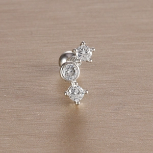Detailed macro view of silver leaf ear bone stud featuring three white zircon stones
