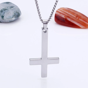 Silver inverted cross pendant necklace with box chain for men on natural stone props