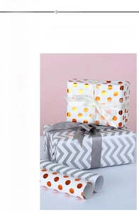 Detail of striped and polka dot gift wrapping paper with satin ribbons on gift boxes