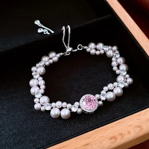 French style pearl bracelet featuring a pink gemstone pendant and adjustable slider clasp