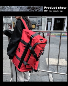 Detail of red oxford travel backpack with adjustable straps and side zipper pocket