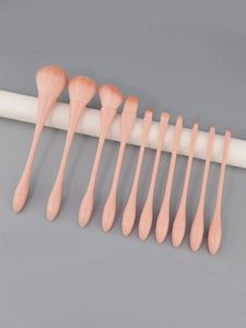 Detail of 11-piece pink makeup brush set with ergonomic handles and soft gradient bristles