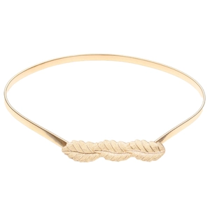 Detailed view of a golden elastic spring belt featuring an elegant metal leaf buckle