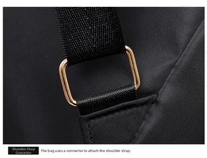 Close-up of golden metal buckle and durable nylon strap connection on the black backpack