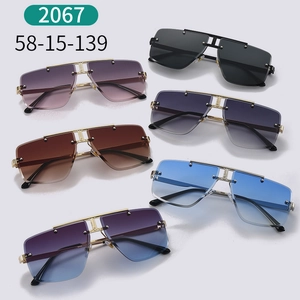 Detail view showing variety of rimless oversized sunglasses with metal bridge and rivets