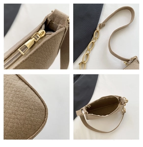 Detailed close-up of beige handbag with gold hardware, zipper, and textured fabric