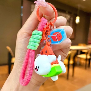 Detail of watermelon themed dog keychain with pink braided cord and cute silicone charm
