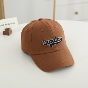 Close-up of brown cotton baseball cap with white Sunday embroidery and fine twill texture