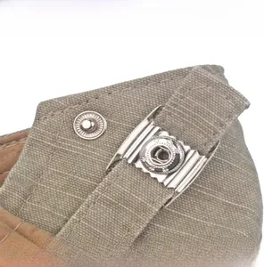 Detail of adjustable metal buckle and stitching on washed cotton newsboy cap