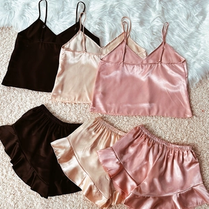 Three silk satin pajama sets with camisole tops and ruffled shorts in multiple colors