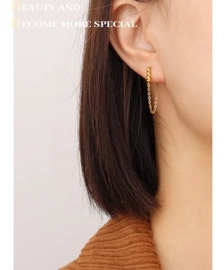 Detail of twisted gold chain fringe earrings on model for a chic vintage look