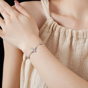 Detailed view of silver flower bracelet featuring sparkling cubic zirconia on a wrist